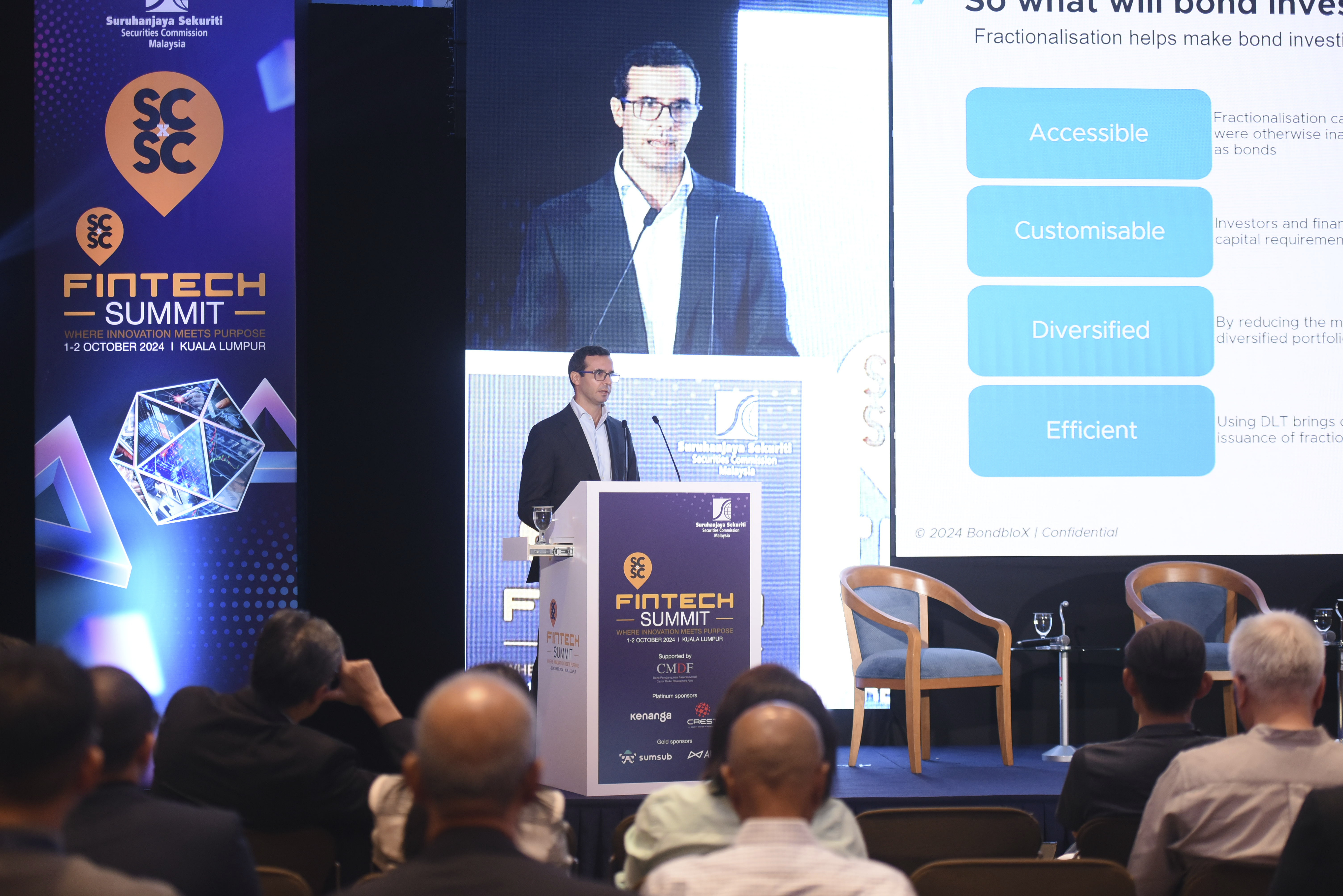 Business conference audience engaged during a keynote session in Malaysia.