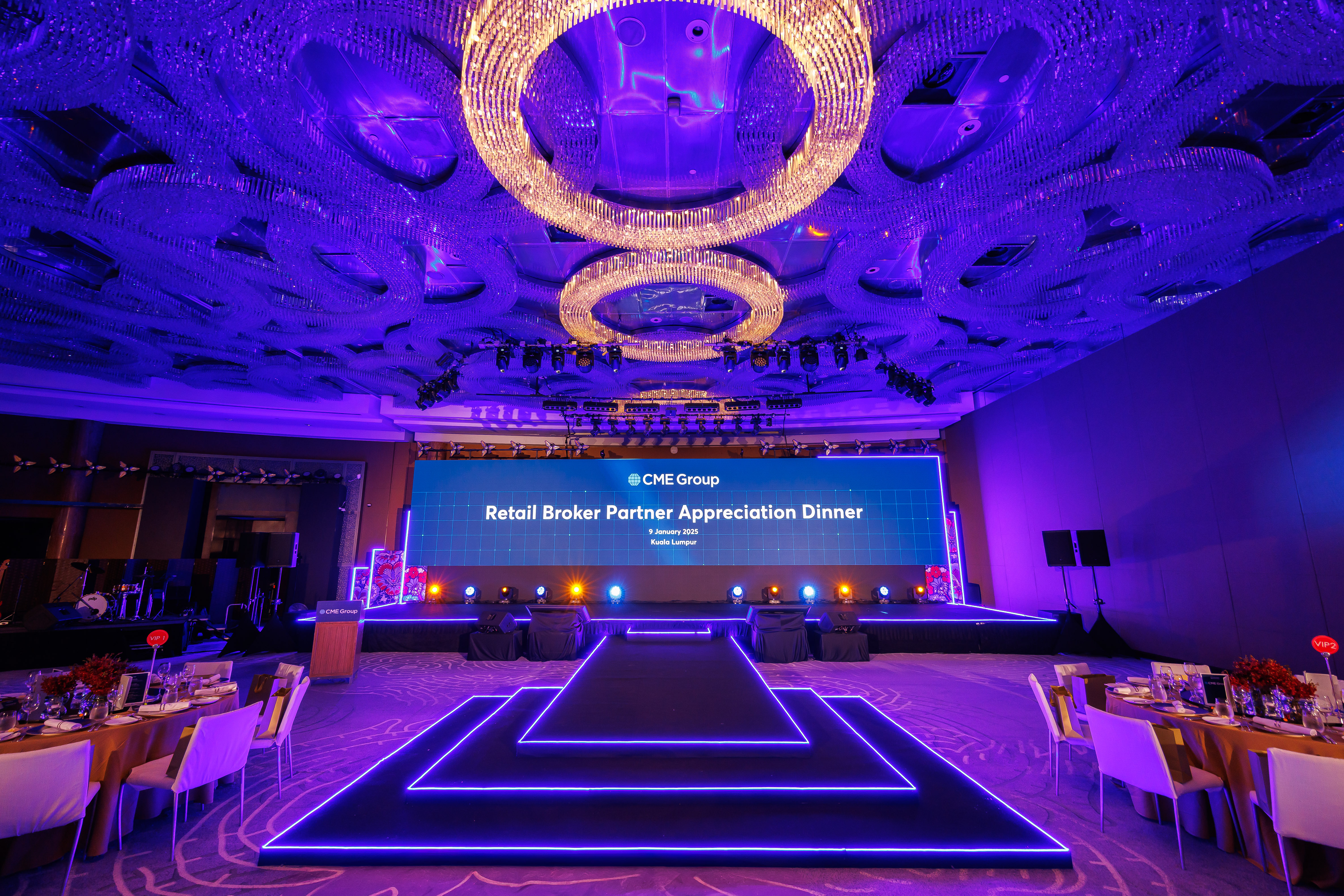 Premium corporate dinner event setup with LED stage design, runway lighting, and elegant ballroom ambience by a professional event management team. CME Appreciation Dinner.