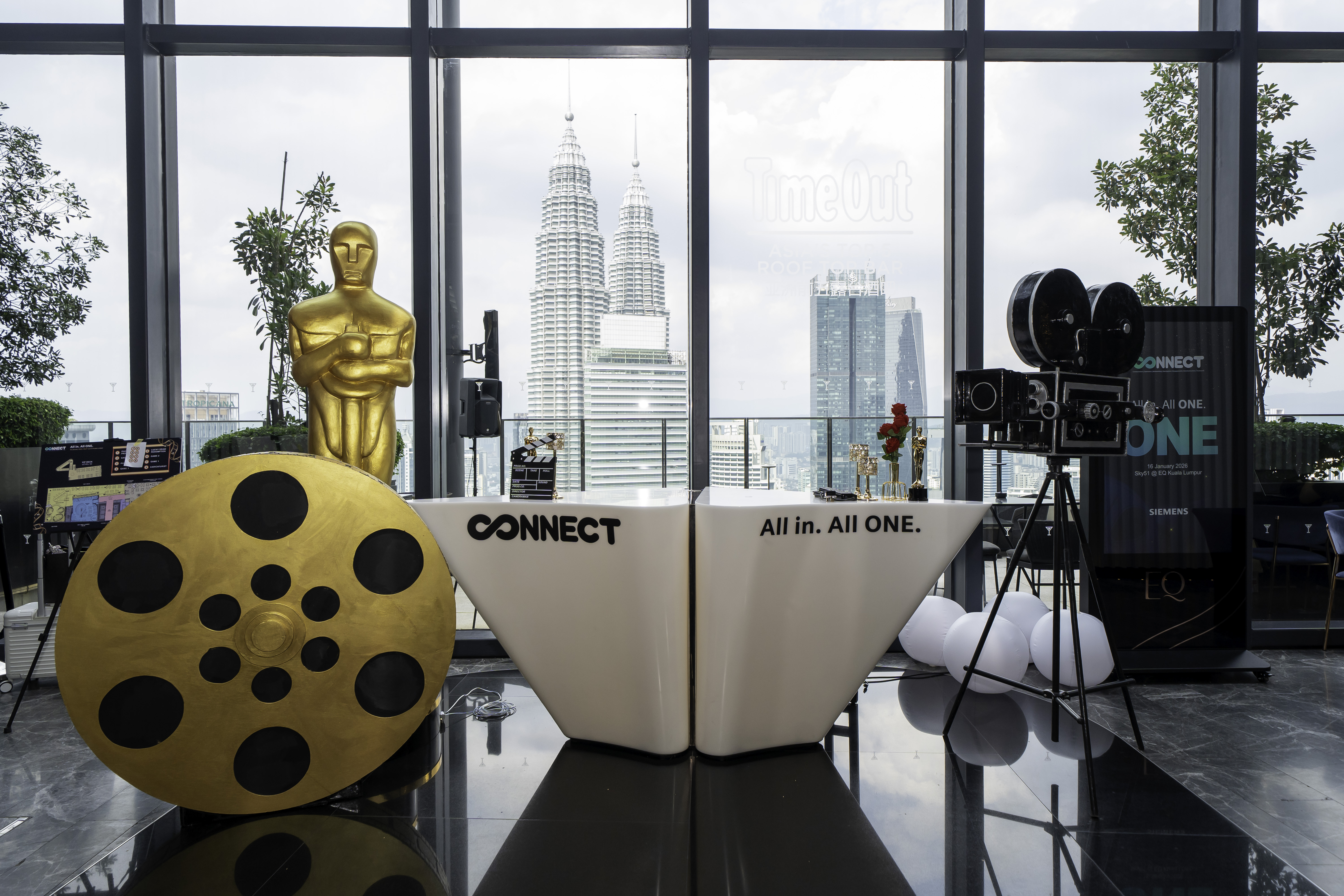 Event company in KL styling a themed rooftop conference with Petronas Twin Towers skyline backdrop.